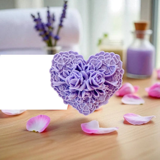 Heart-shaped purple soap with floral design on a wooden surface with pink petals