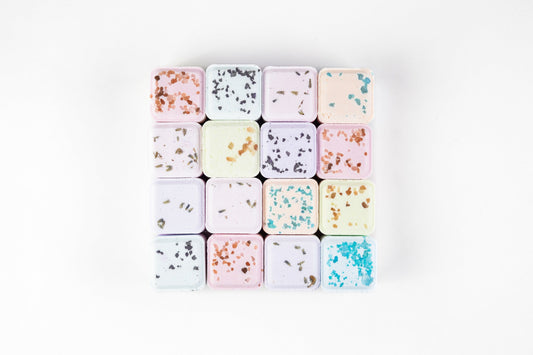 Grid of individual square shower steamers in pastel colors with floral flecks