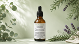 A 50ml amber glass dropper bottle of Whiteout Root Cause Hair Growth Serum, styled with eucalyptus and lavender sprigs on a light green background.